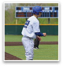 A baseball player wearing a blue helmet and blue and white uniform is bending over on the field. AI generated content