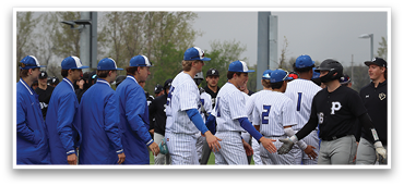 A group of baseball players wearing blue and white uniforms are standing on a field. AI generated content