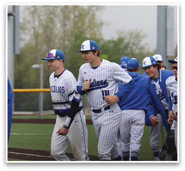 A group of baseball players wearing blue and white uniforms are walking on a field. AI generated content