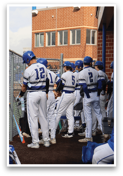 A group of baseball players standing on a field. Description generated by AI
