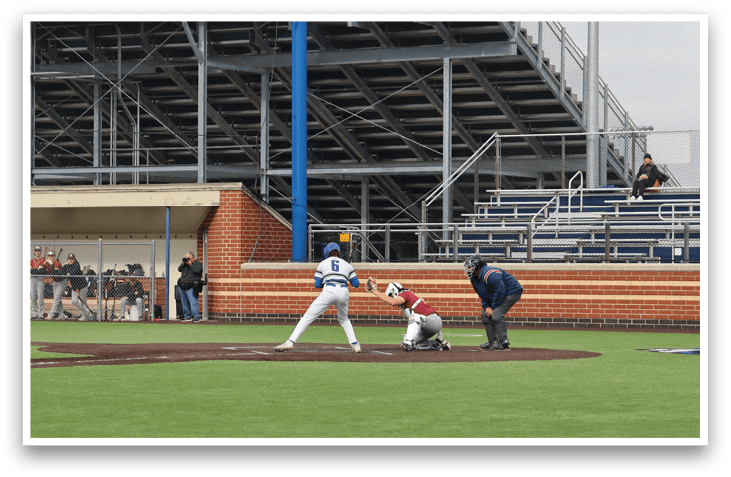 A baseball player is swinging a bat on a field. Description generated by AI