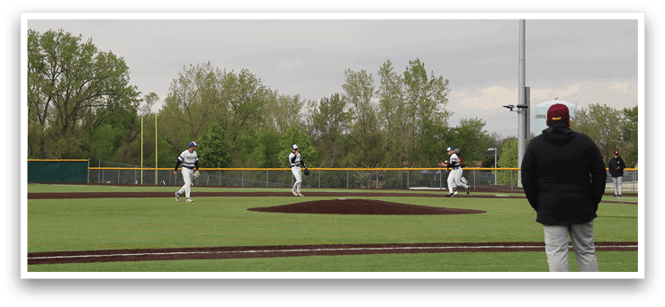 A baseball game is being played on a field. Description generated by AI