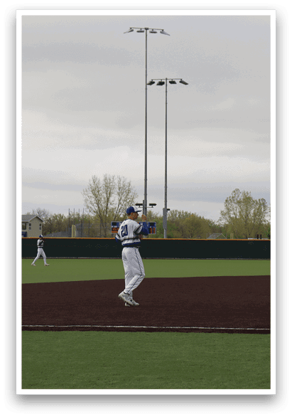 A baseball game is taking place on a field with a group of men playing. Description generated by AI