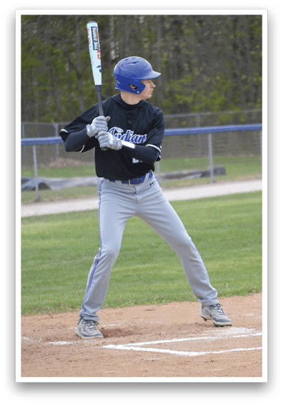 A baseball player in a blue helmet and black shirt is holding a bat and getting ready to hit the ball. Description generated by AI