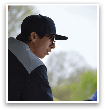 A man wearing a black hat and glasses. Description generated by AI