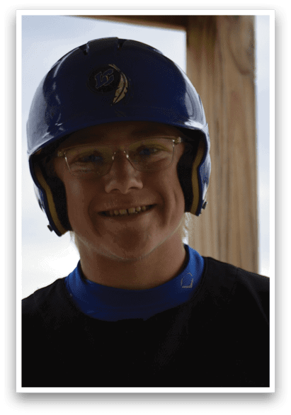 A young man wearing a blue and yellow helmet. Description generated by AI