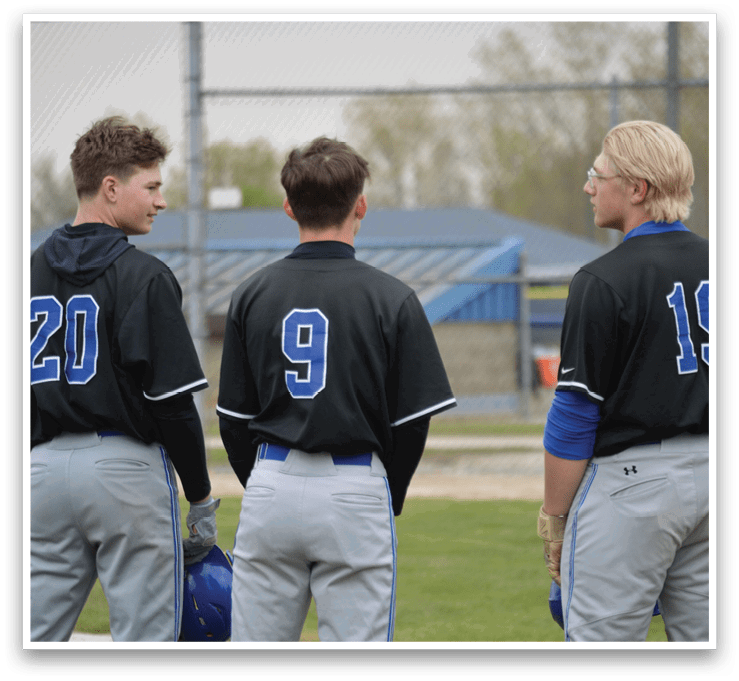 Three baseball players wearing black shirts and blue pants. Description generated by AI