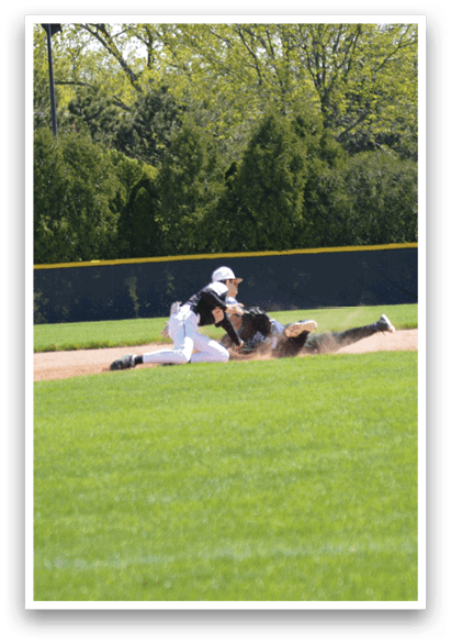 A baseball player slides into a base. Description generated by AI