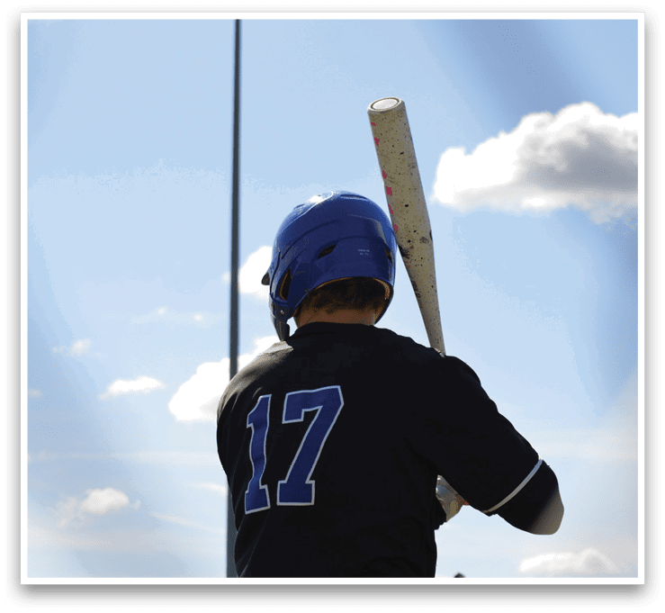 A baseball player wearing a blue helmet and black shirt holding a bat. Description generated by AI