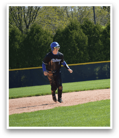A baseball player wearing a blue and black uniform is running on the field. Description generated by AI