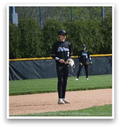 A baseball player standing on the field. Description generated by AI