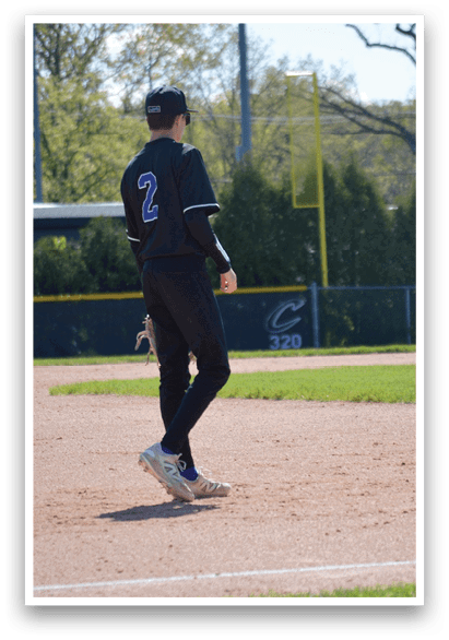 A baseball player wearing a black shirt and white shoes. Description generated by AI