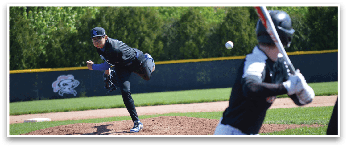 A baseball player in a black shirt and white pants is throwing a ball. Description generated by AI
