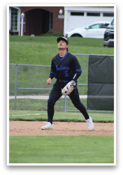 A baseball player wearing a black shirt and white shoes. Description generated by AI