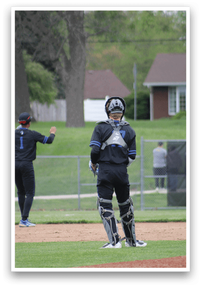 A baseball player wearing a black and blue uniform. Description generated by AI
