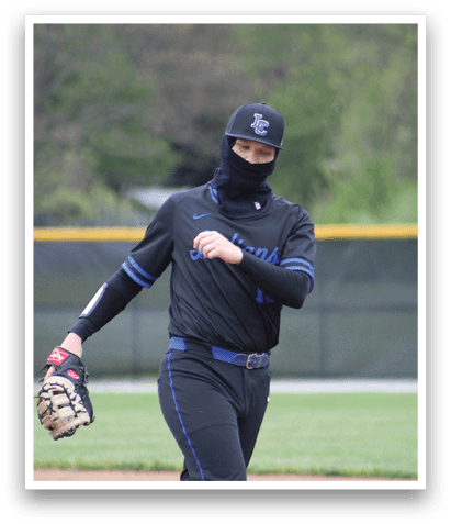 A baseball player wearing a black shirt and a blue belt. Description generated by AI