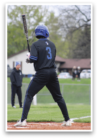 A baseball player is holding a bat and getting ready to swing. Description generated by AI