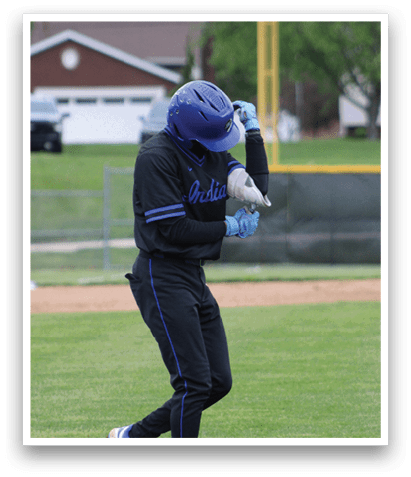 A person wearing a blue helmet and black shirt is holding a bat. Description generated by AI