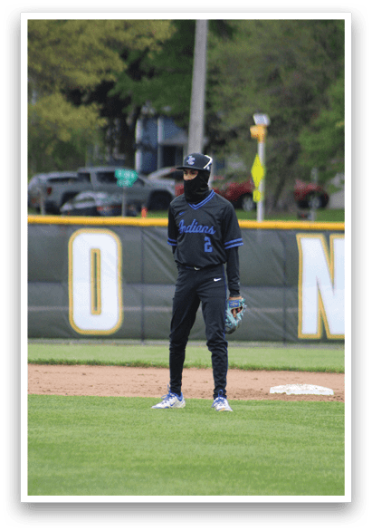 A baseball player in a black uniform with a blue number 2 on the back. Description generated by AI