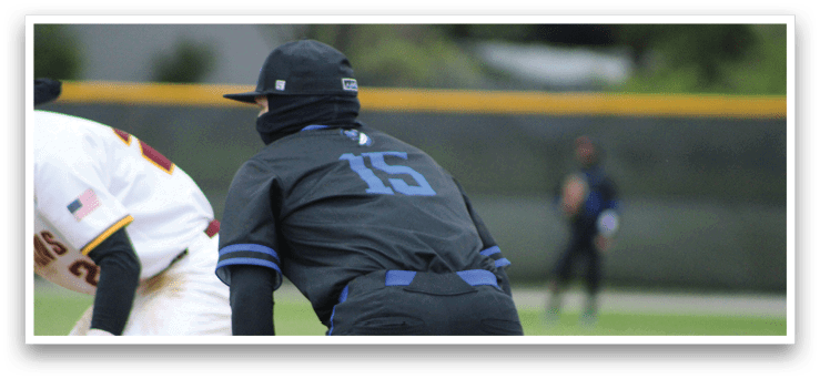 A baseball player wearing a black shirt with the number 15 on it. Description generated by AI