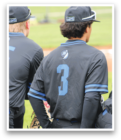 A baseball player wearing a black shirt with the number 3 on it. Description generated by AI