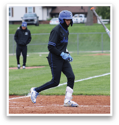 A baseball player is holding a bat and standing on the field. Description generated by AI