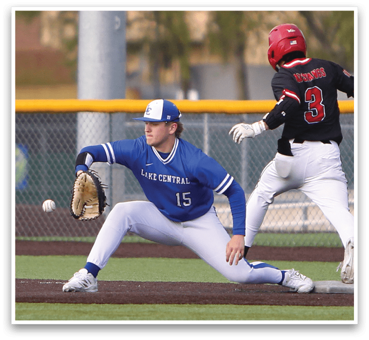 A baseball player in a blue uniform is bending over to catch a ball. Description generated by AI