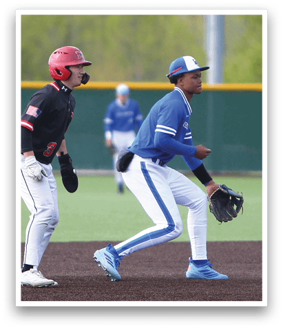 A baseball player in a blue uniform is running towards a base. Description generated by AI
