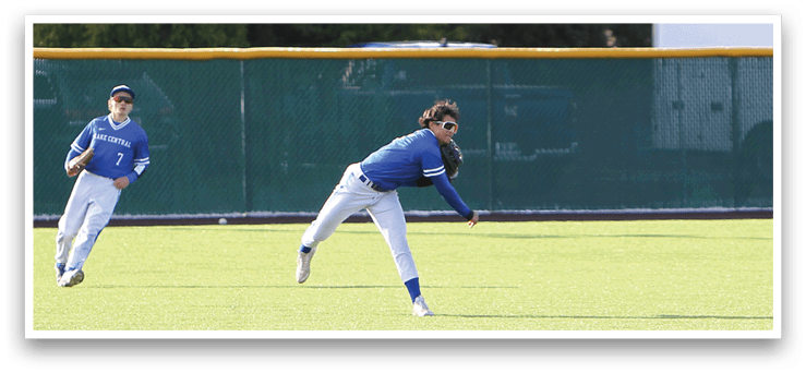 A baseball player in a blue shirt and white pants is running towards a base. Description generated by AI