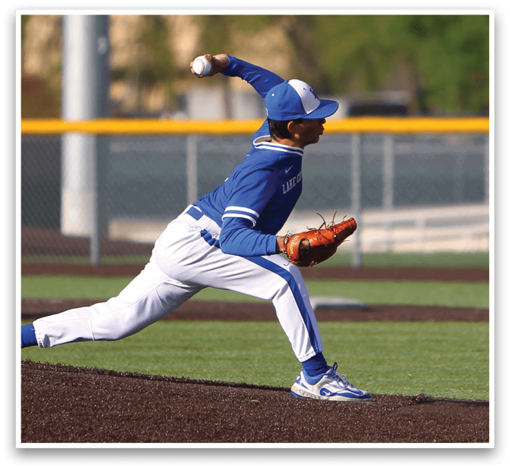 A baseball player in a blue and white uniform is throwing a ball. Description generated by AI