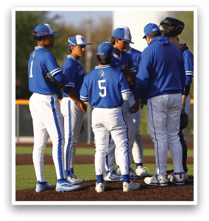 A group of baseball players wearing blue and white uniforms. Description generated by AI