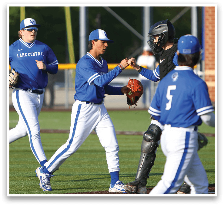 A baseball player wearing a blue shirt and white pants. Description generated by AI