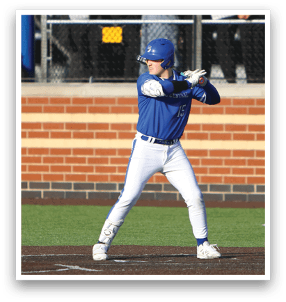 A baseball player in a blue and white uniform is swinging a bat. Description generated by AI
