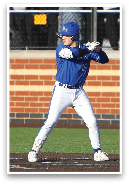 A baseball player in a blue and white uniform is swinging a bat. Description generated by AI