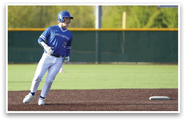 A baseball player wearing a blue and white uniform. Description generated by AI