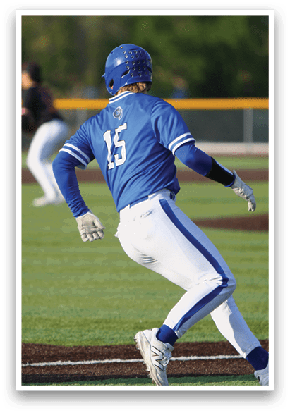 A baseball player wearing a blue helmet and white pants is running towards home plate. Description generated by AI