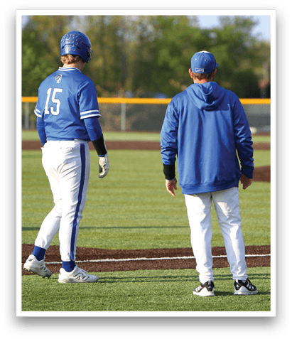 A baseball player wearing a blue and white uniform. Description generated by AI