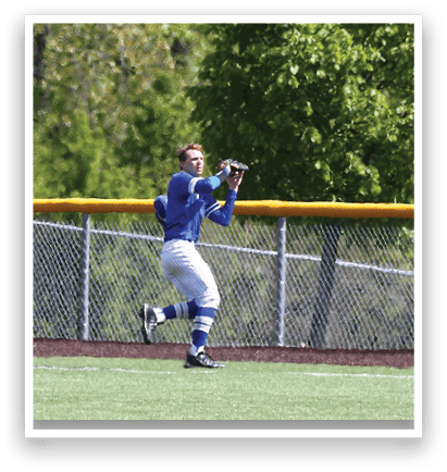 A baseball player wearing blue and white catching a ball. Description generated by AI