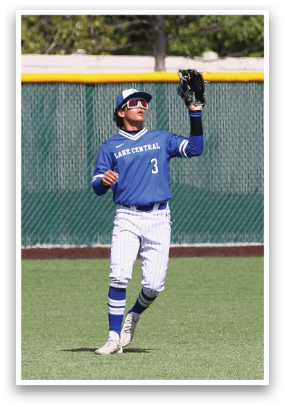A baseball player wearing a blue shirt and white pants. Description generated by AI