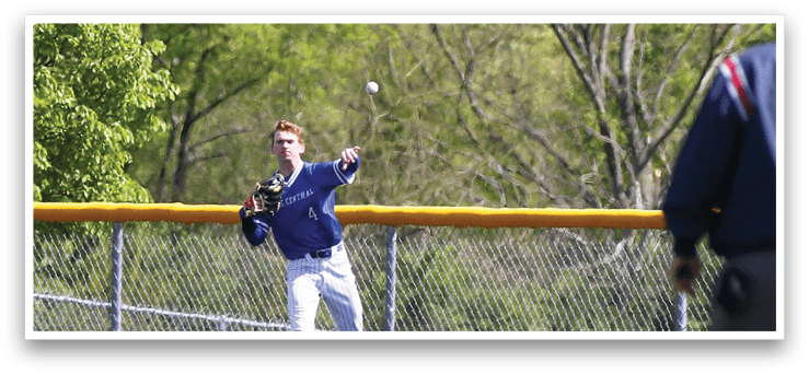 A baseball player in a blue shirt and white pants is throwing a ball. Description generated by AI