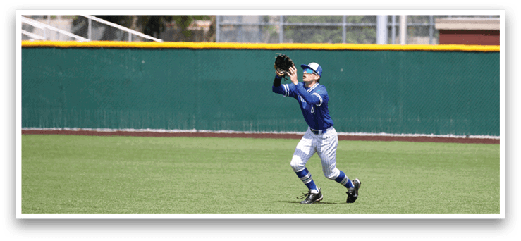 A baseball player wearing a blue and white uniform is catching a ball. Description generated by AI