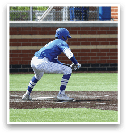 A baseball player in a blue uniform is crouching down to catch a ball. Description generated by AI