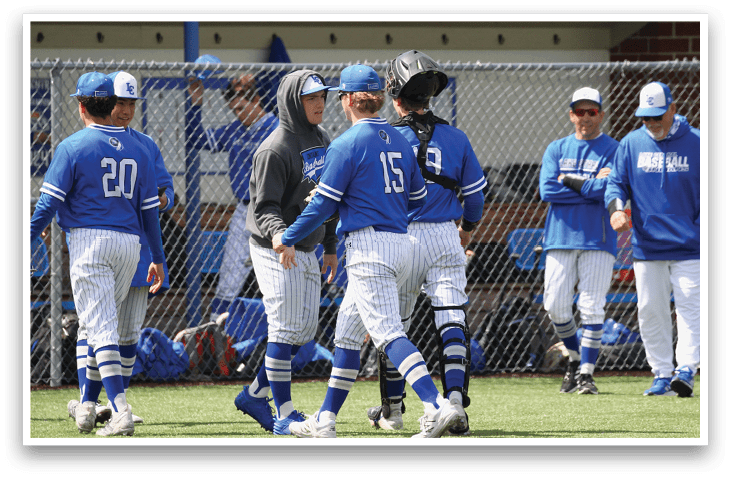 Baseball players wearing blue and white uniforms. Description generated by AI