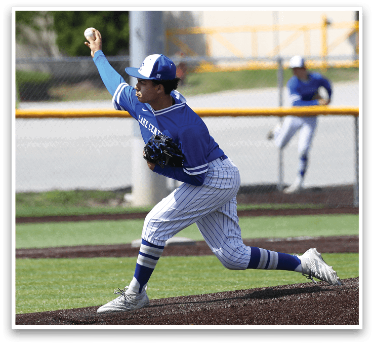 A baseball player in a blue and white uniform is throwing a ball. Description generated by AI
