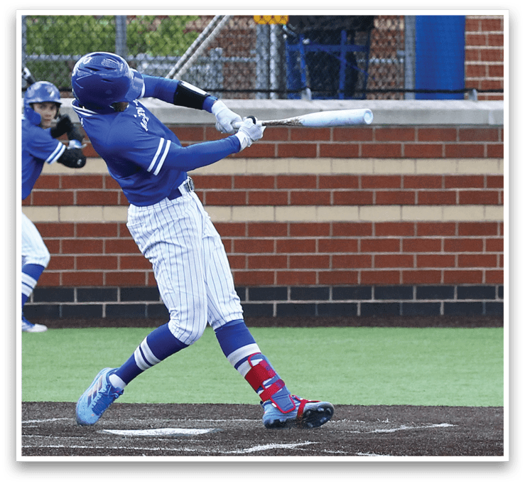A baseball player in a blue and white uniform is swinging a bat at a ball. Description generated by AI
