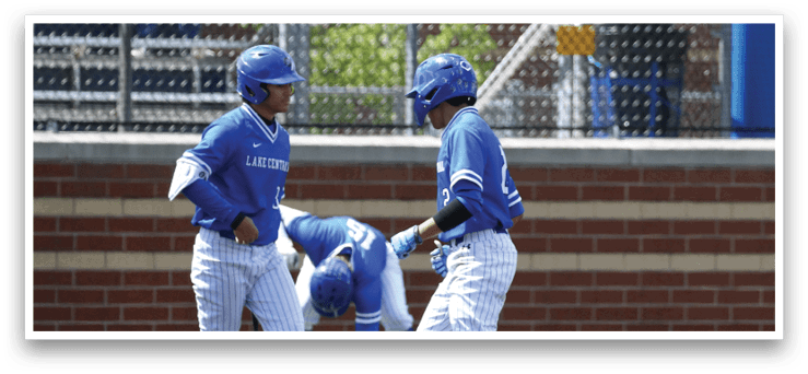 Two baseball players wearing blue and white uniforms. Description generated by AI