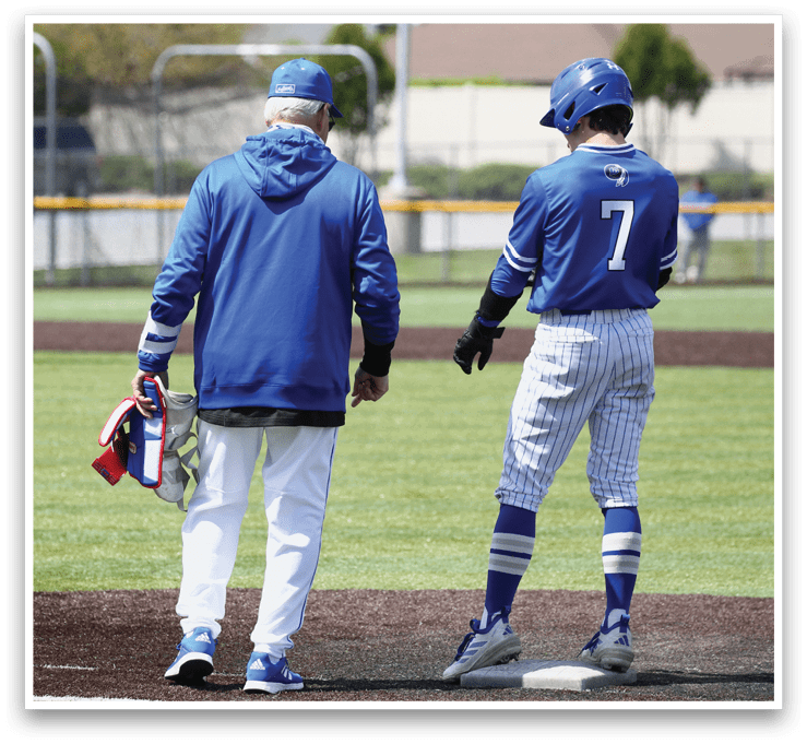 Two men wearing blue and white uniforms. Description generated by AI