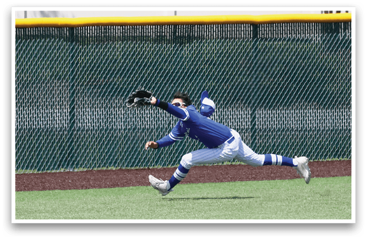A baseball player in a blue shirt and white pants is running towards a base. Description generated by AI