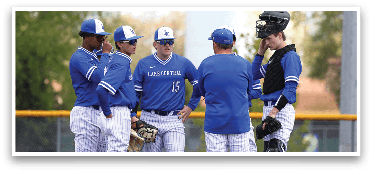 A group of baseball players wearing blue uniforms. Description generated by AI