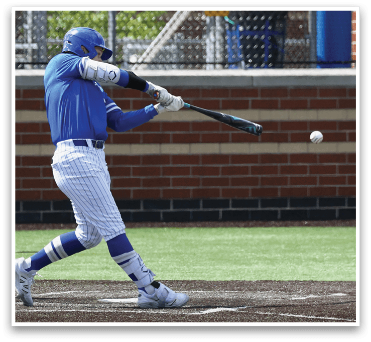 A baseball player in a blue uniform is swinging a bat at a ball. Description generated by AI